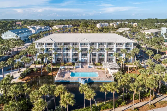 a view of a balcony with wooden floor next to a city view