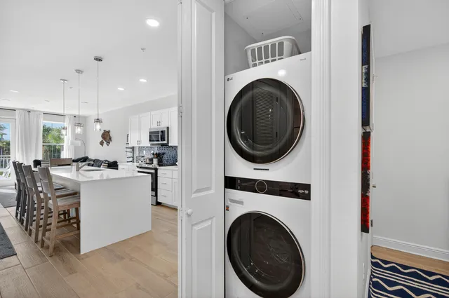 a kitchen with a sink white cabinets and white appliances