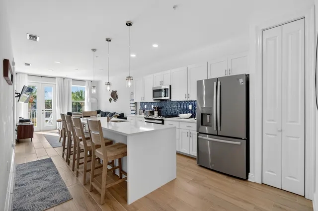 a kitchen with appliances a sink and cabinets