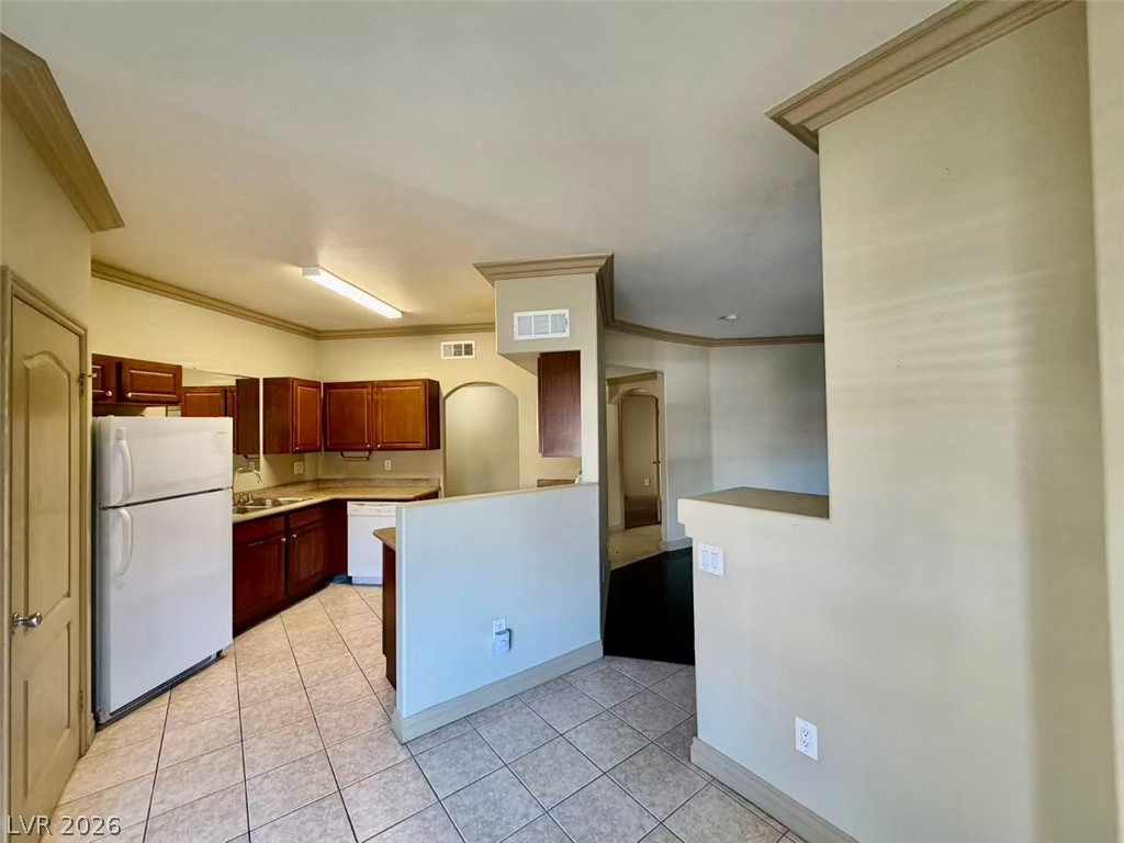 5525 West Flamingo Road, Unit 1019 Las Vegas, NV 89103 - Photo 4 of 18 Functional kitchen with ample cabinet space and a practical tile floor, ideal for everyday living.