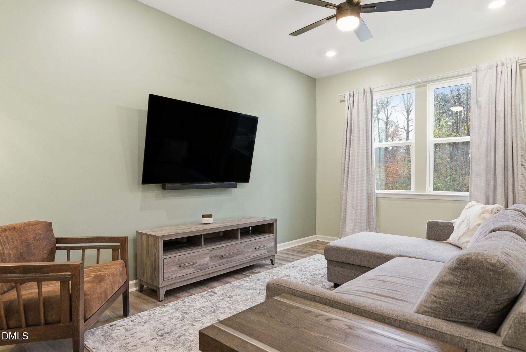 449 Hacksaw Trail Raleigh, NC 27610 - Photo 8 of 36 a living room with furniture and a flat screen tv