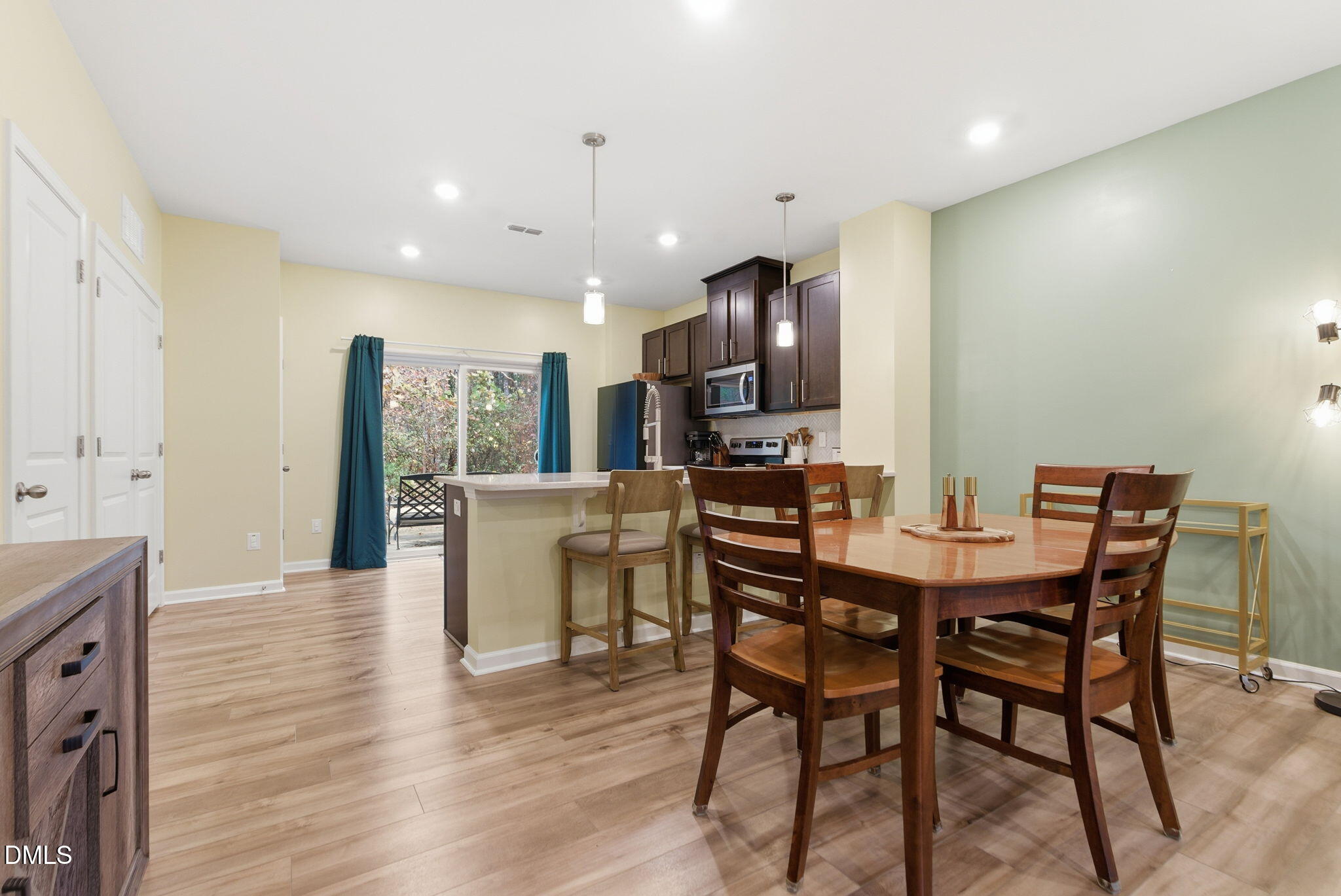 449 Hacksaw Trail Raleigh, NC 27610 - Photo 12 of 36 a view of a dining room with furniture and wooden floor