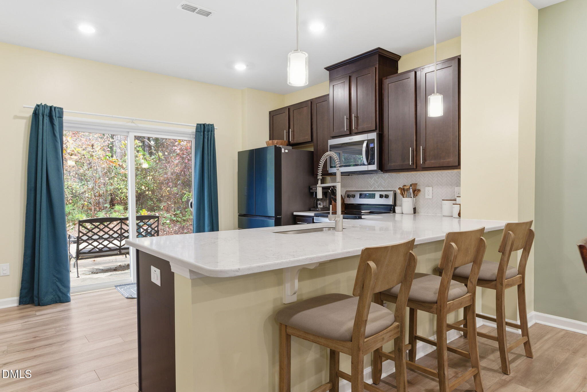 449 Hacksaw Trail Raleigh, NC 27610 - Photo 13 of 36 a kitchen with stainless steel appliances granite countertop a refrigerator a stove top oven and a sink with granite countertops