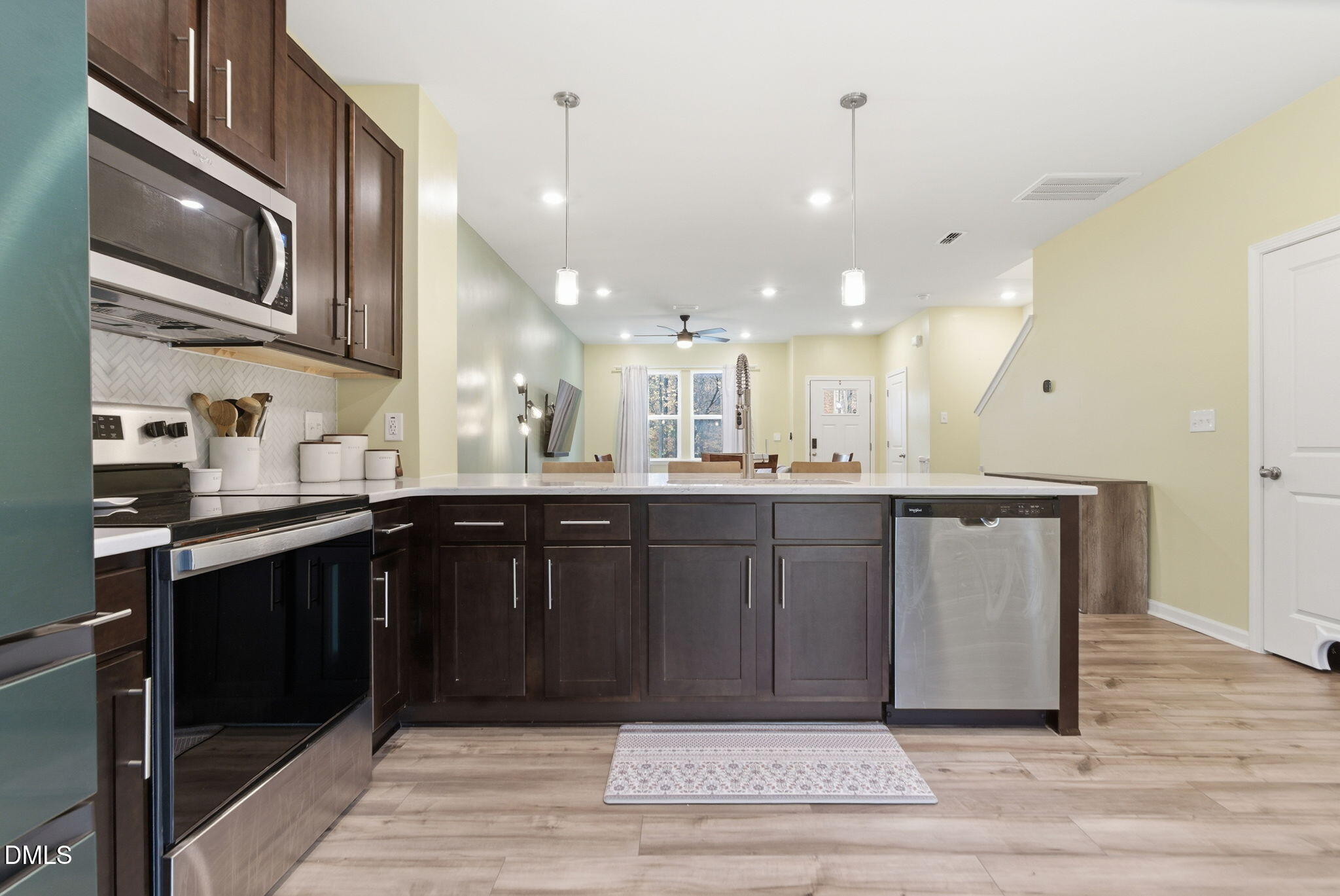 449 Hacksaw Trail Raleigh, NC 27610 - Photo 15 of 36 a kitchen with a sink cabinets and wooden floor