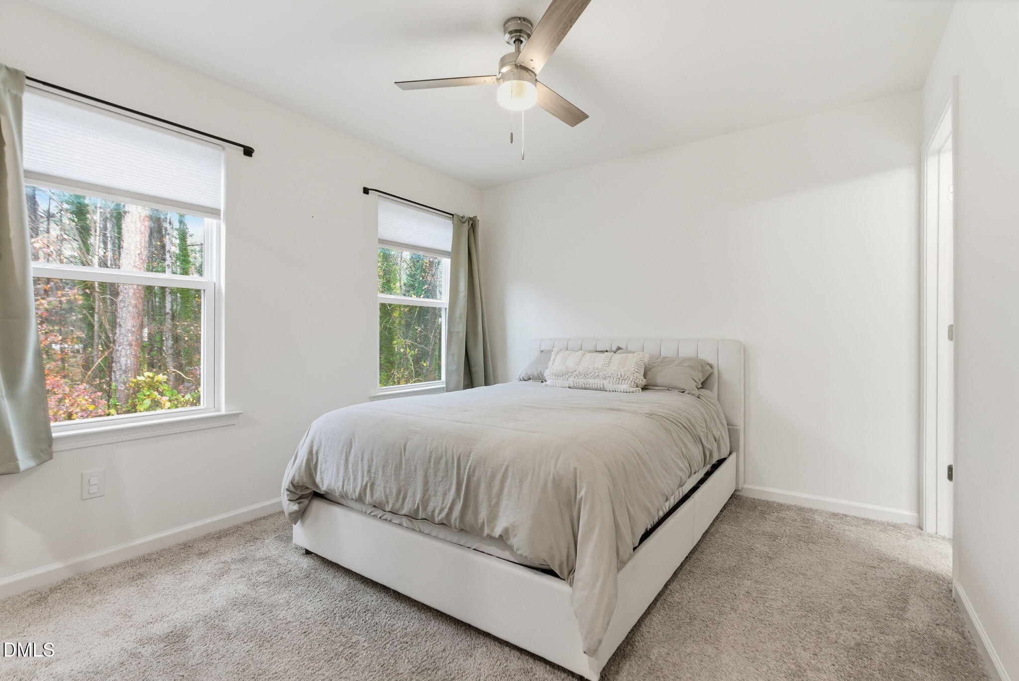 449 Hacksaw Trail Raleigh, NC 27610 - Photo 18 of 36 a bed sitting in a bedroom next to a window
