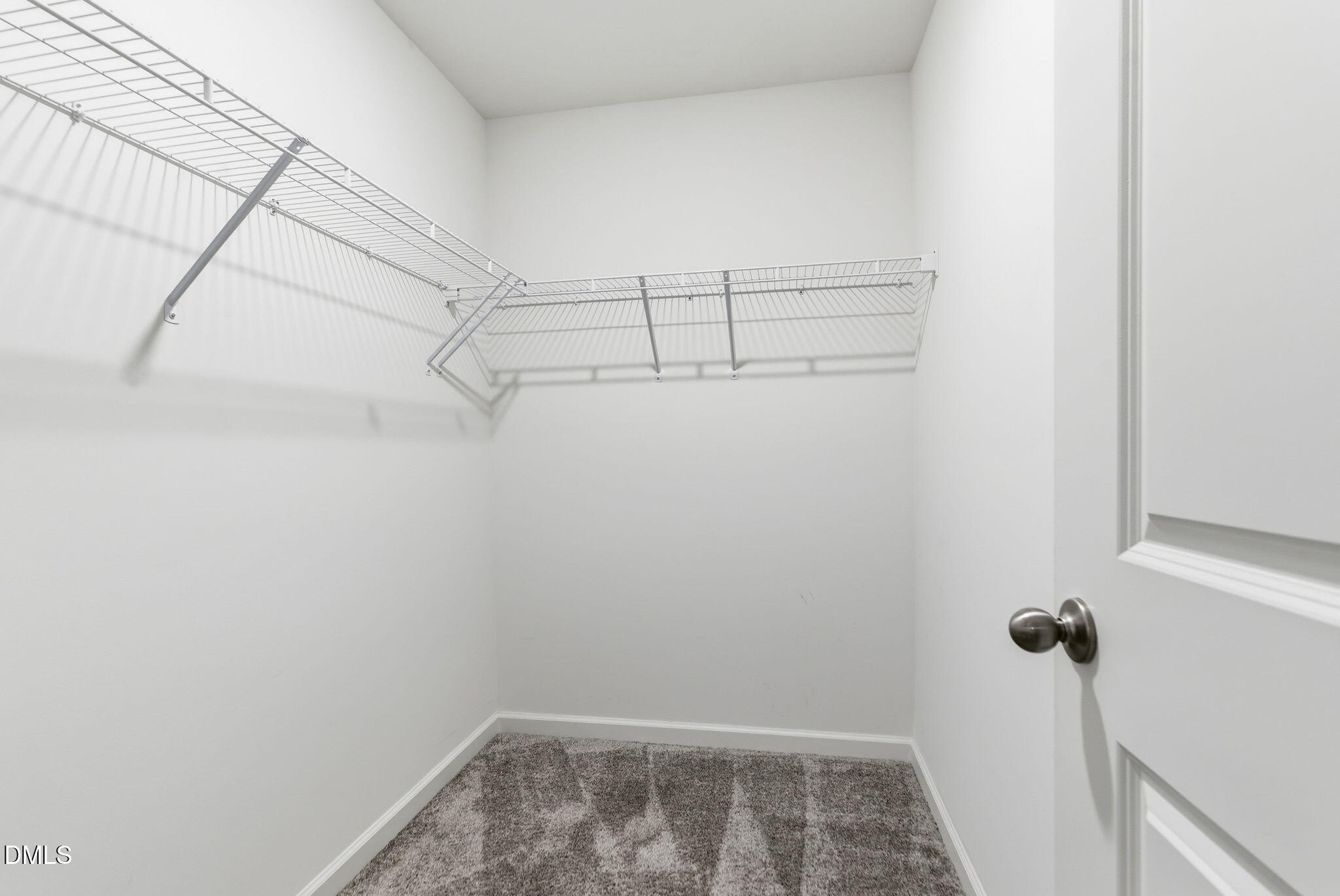 449 Hacksaw Trail Raleigh, NC 27610 - Photo 21 of 36 a view of storage and utility room with racks on the wall