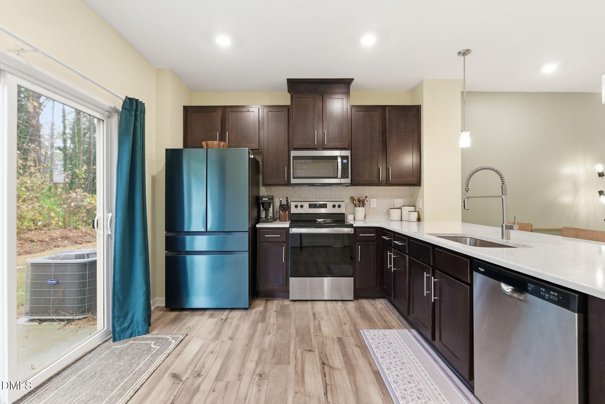 449 Hacksaw Trail Raleigh, NC 27610 - Photo 4 of 36 a kitchen with a refrigerator a sink and wooden floor