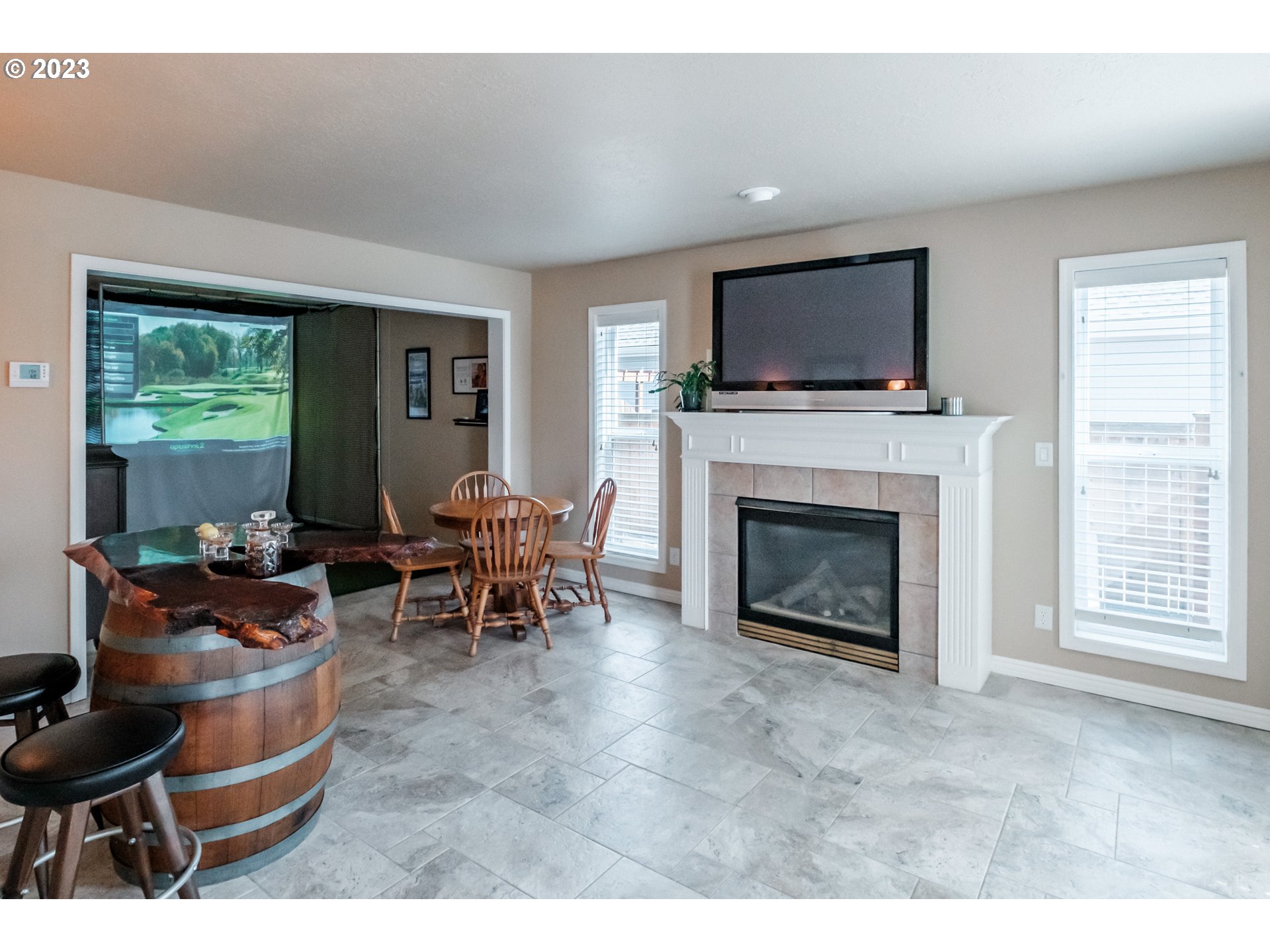 5165 Falcon Street Southwest Albany, OR 97321 - Photo 3 of 28 a living room with furniture a flat screen tv and a fireplace