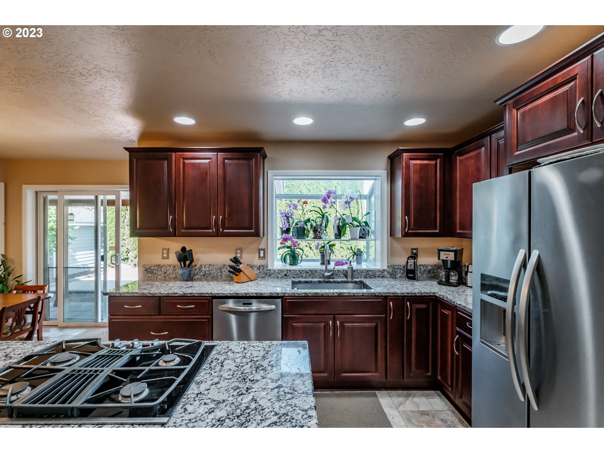 5165 Falcon Street Southwest Albany, OR 97321 - Photo 7 of 28 a kitchen with kitchen island granite countertop a sink stainless steel appliances and cabinets