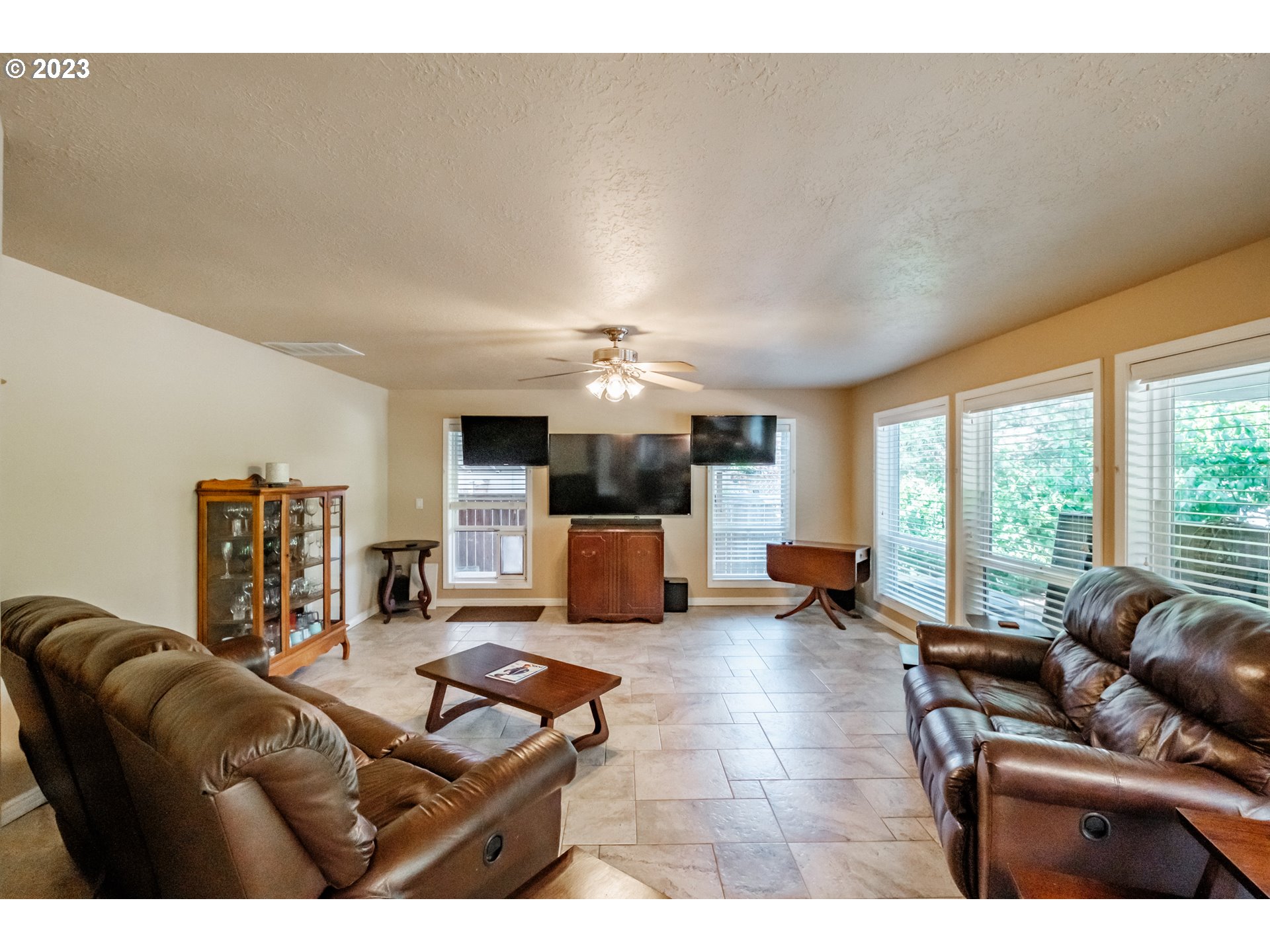 5165 Falcon Street Southwest Albany, OR 97321 - Photo 9 of 28 a living room with furniture a large window and kitchen view