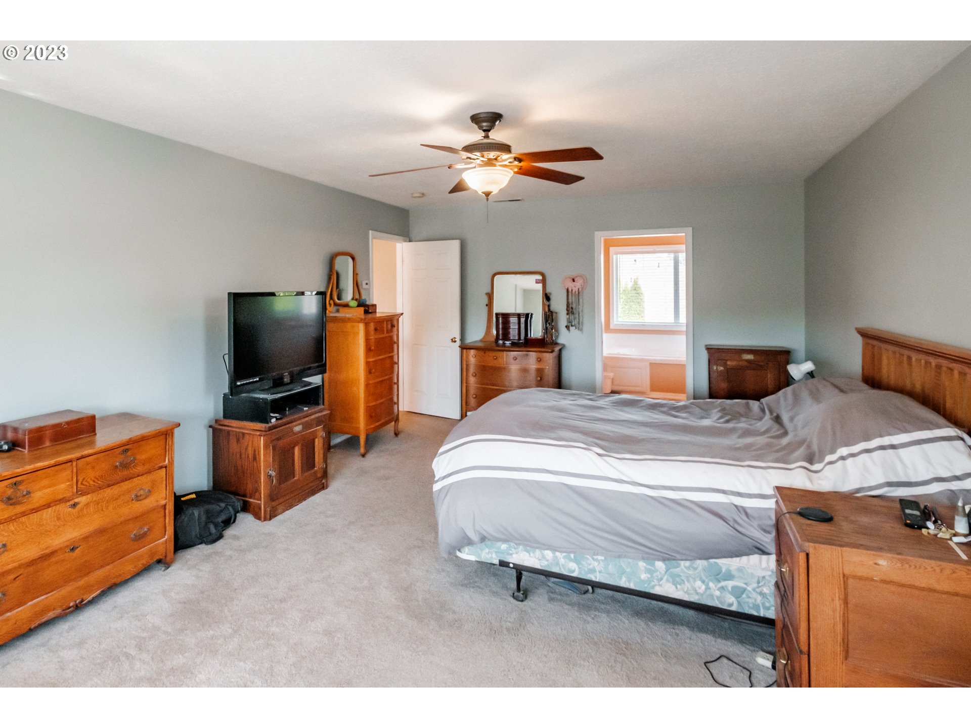 5165 Falcon Street Southwest Albany, OR 97321 - Photo 10 of 28 a bedroom with a bed and a flat screen tv