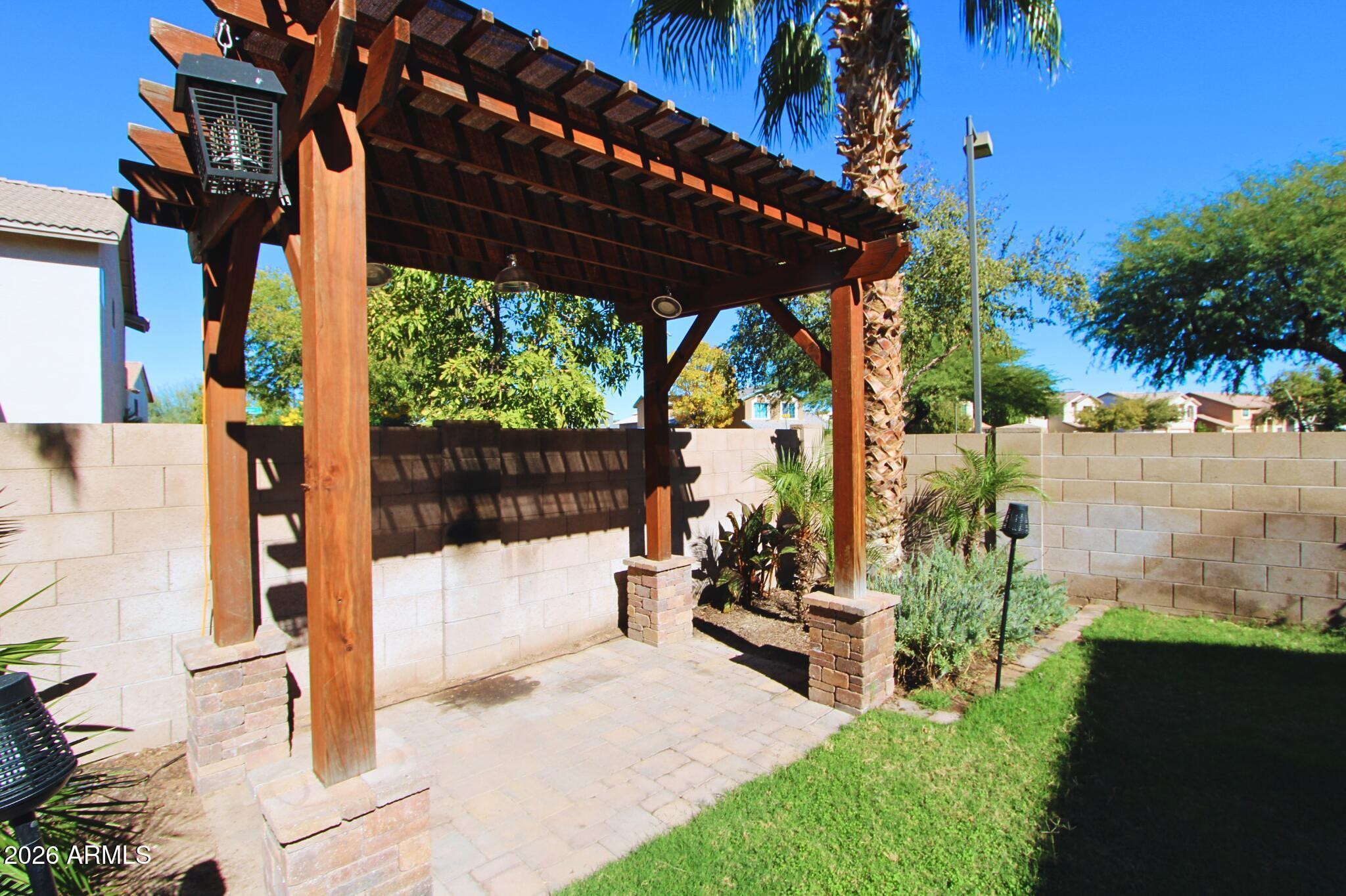 1250 South Palm Street Gilbert, AZ 85296 - Photo 20 of 33 a view of a patio with table and chairs potted plants with wooden fence