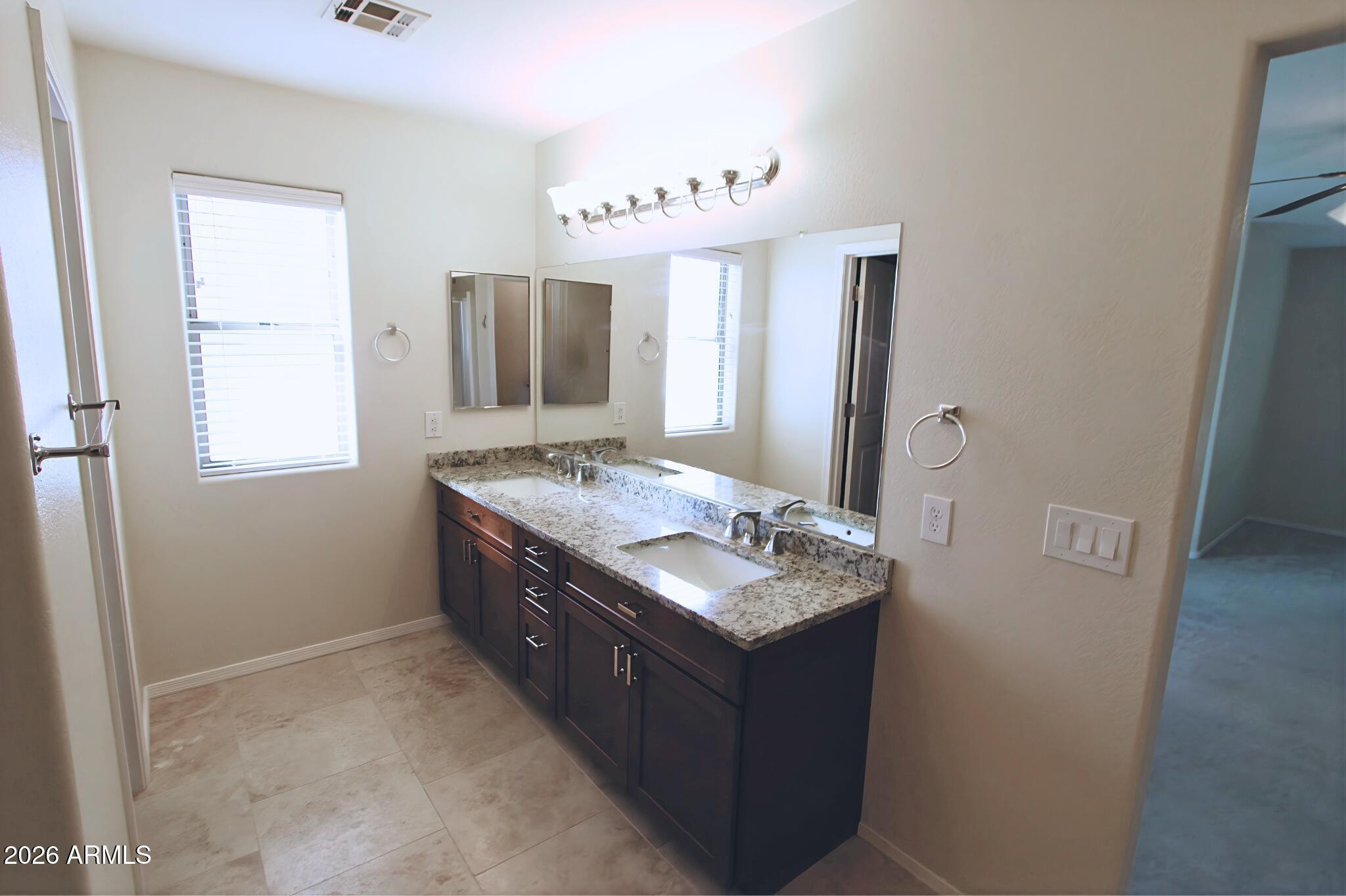 1250 South Palm Street Gilbert, AZ 85296 - Photo 28 of 33 a bathroom with sinks granite countertop a sink and a mirror