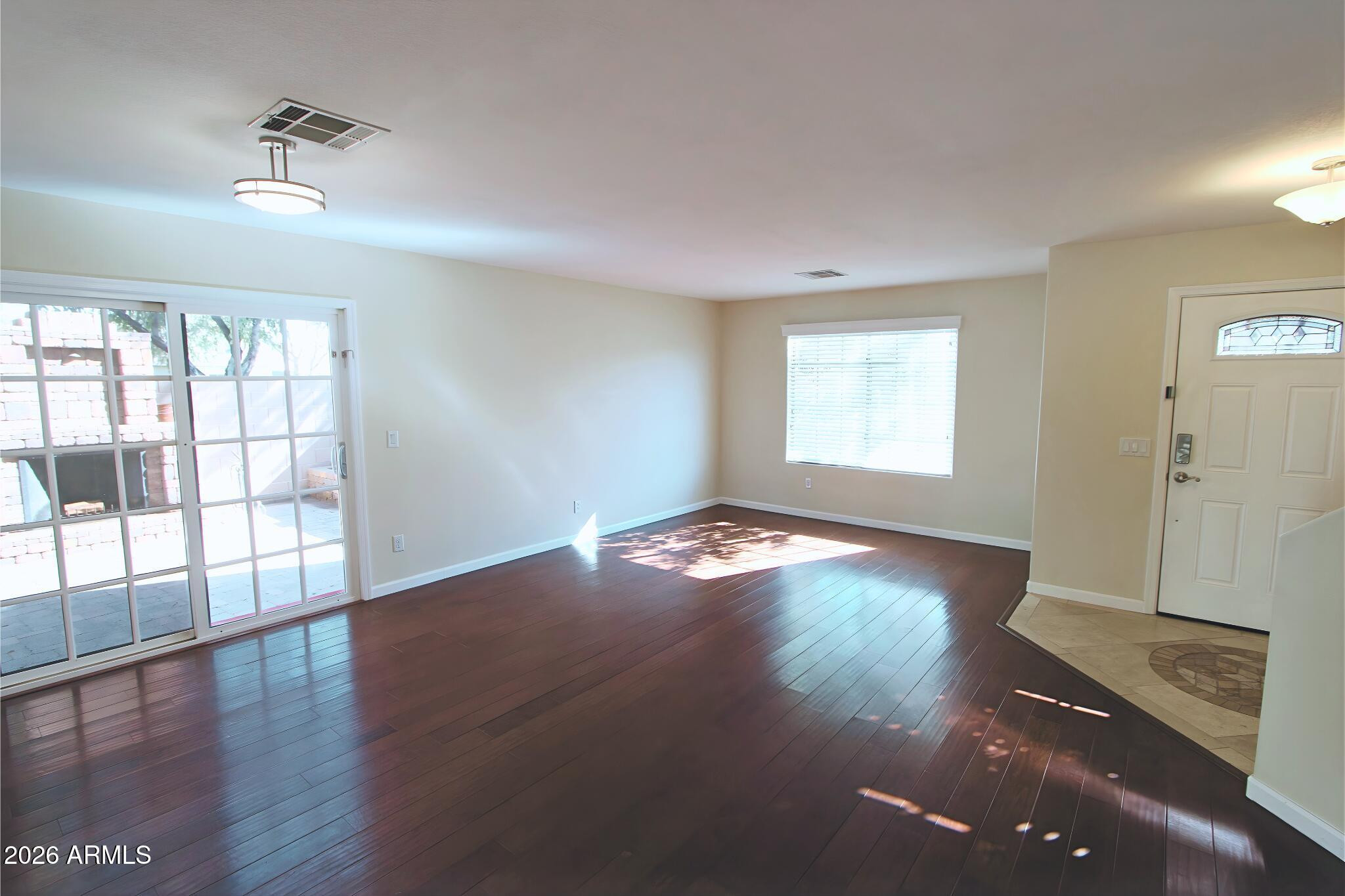 1250 South Palm Street Gilbert, AZ 85296 - Photo 3 of 33 an empty room with wooden floor and windows