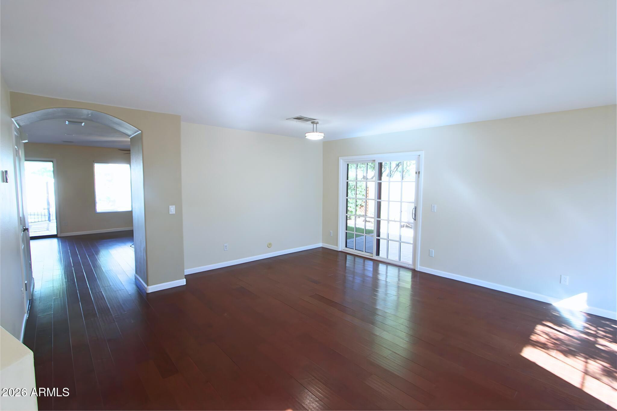 1250 South Palm Street Gilbert, AZ 85296 - Photo 4 of 33 a view of an empty room with wooden floor and a window