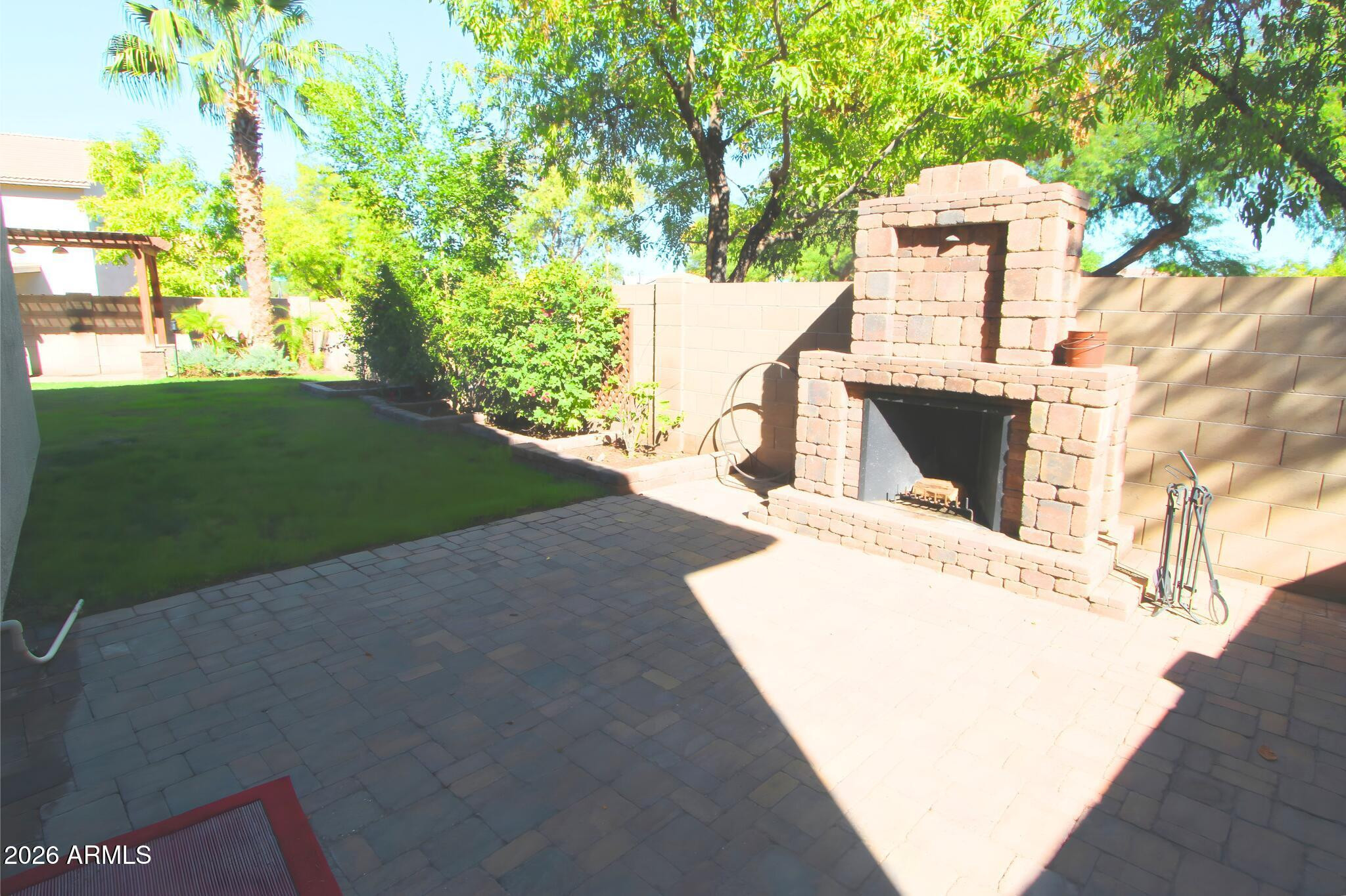 1250 South Palm Street Gilbert, AZ 85296 - Photo 5 of 33 a view of a patio with table and chairs and a fire pit