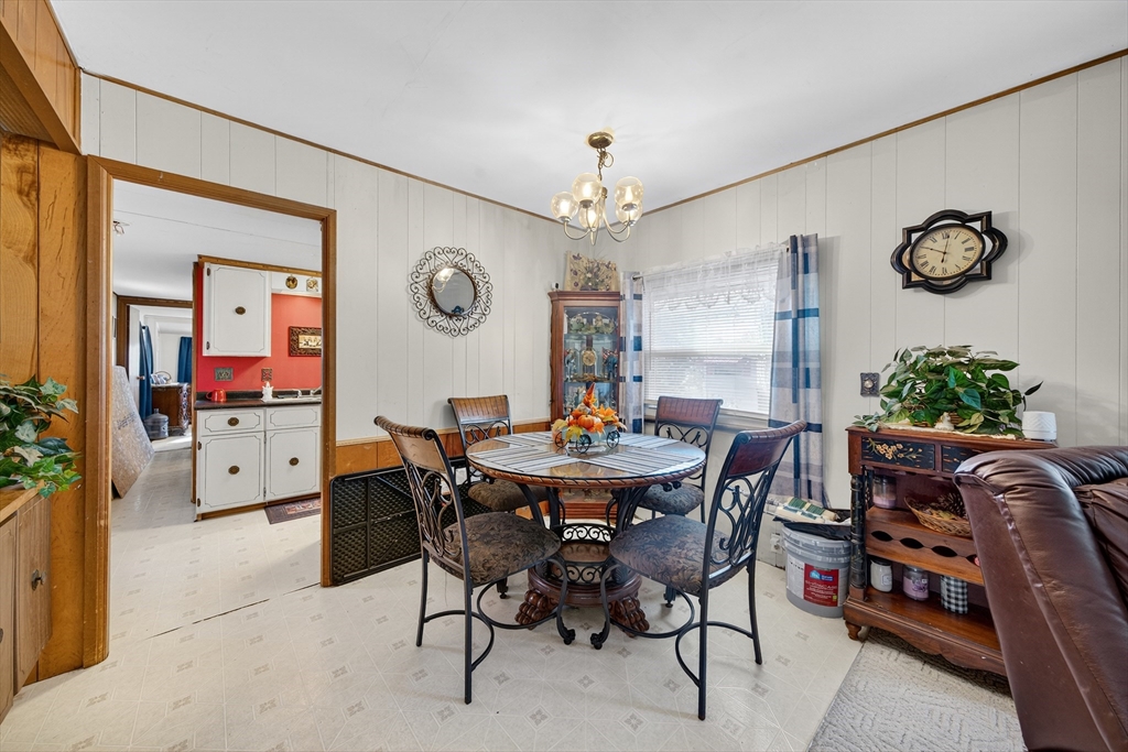 59 Timber Lane Wareham, MA 02576 - Photo 17 of 30 a view of a dining room and livingroom with furniture a rug a potted plant and a chandelier