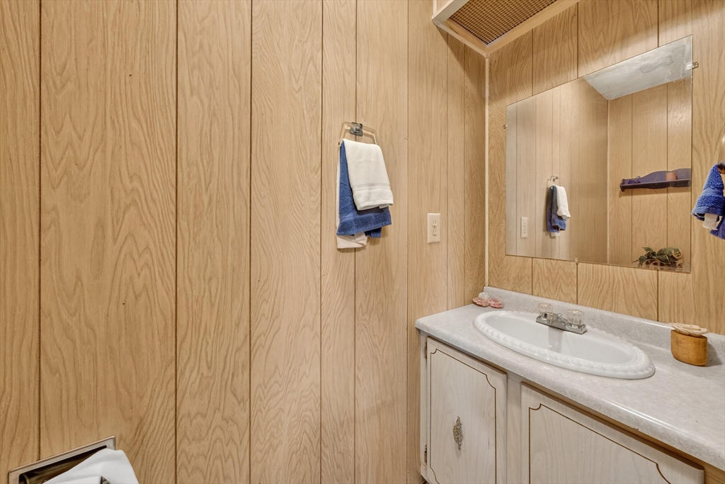 59 Timber Lane Wareham, MA 02576 - Photo 21 of 30 a bathroom with a granite countertop sink and a mirror