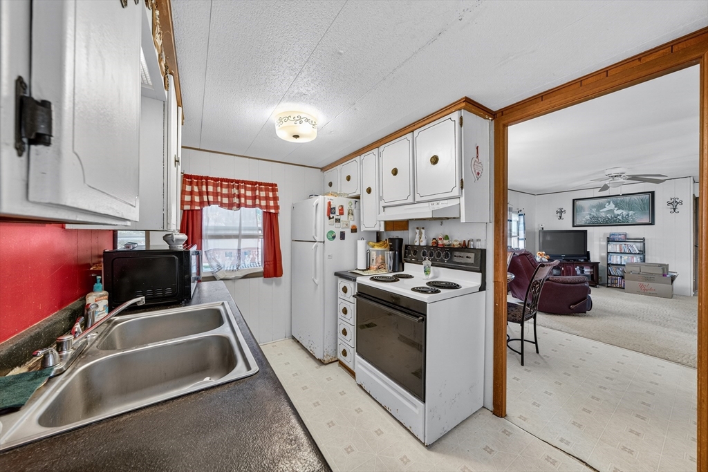59 Timber Lane Wareham, MA 02576 - Photo 25 of 30 a kitchen that has a lot of cabinets in it and appliances