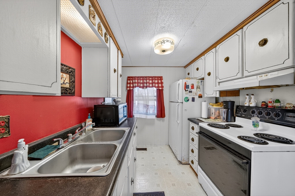 59 Timber Lane Wareham, MA 02576 - Photo 26 of 30 a kitchen that has a sink and a stove