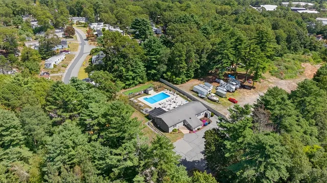 an aerial view of a house with a yard basket ball court and outdoor seating