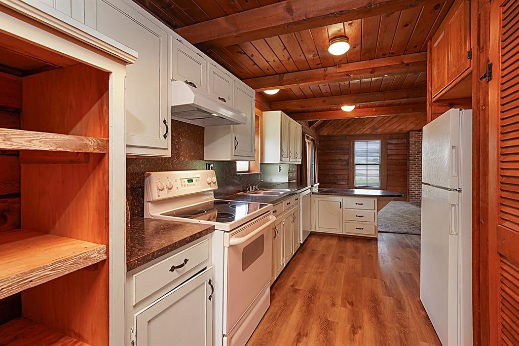 371 Spring Street Forestburg, TX 76239 - Photo 11 of 38 a kitchen that has a lot of cabinets in it
