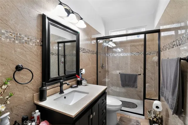 a bathroom with a sink toilet and shower
