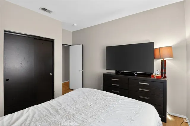 a bedroom with a bed and a flat screen tv