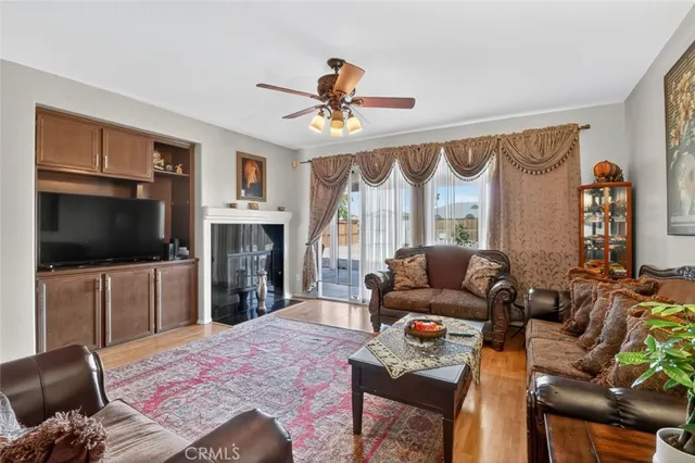 a living room with furniture a flat screen tv and a large window