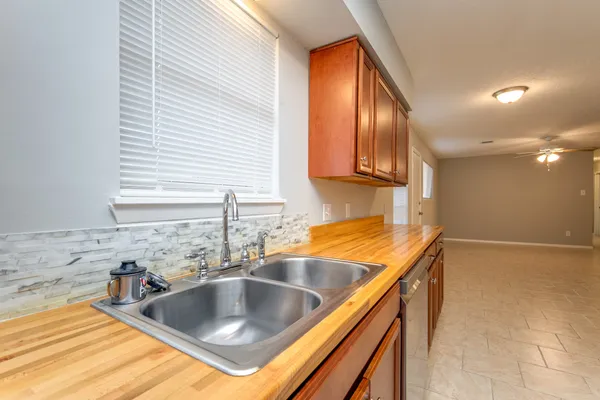 a kitchen with granite countertop a sink and a stove top oven