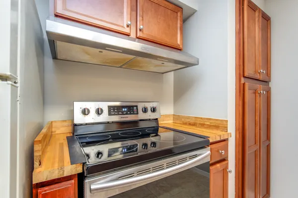 a stove top oven sitting inside of a kitchen