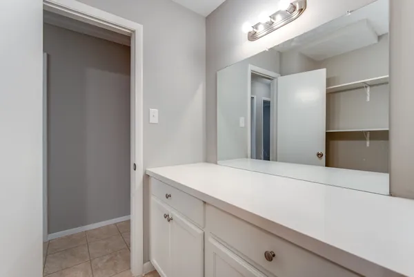 a room with a sink and a mirror