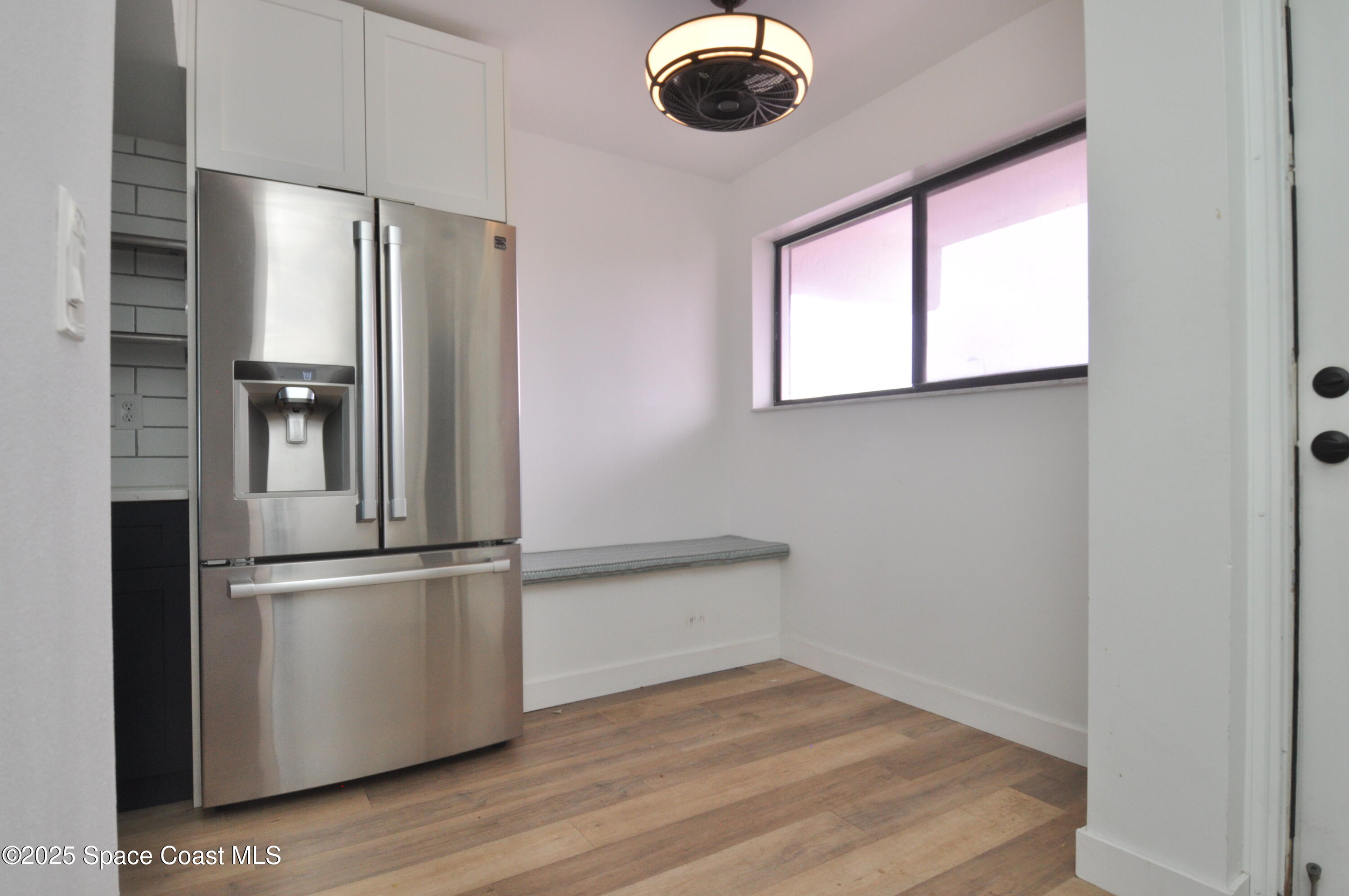 3901 Dixie Highway Northeast, Unit 402 Palm Bay, FL 32905 - Photo 16 of 33 a view of kitchen with stainless steel appliances wooden floor and a window