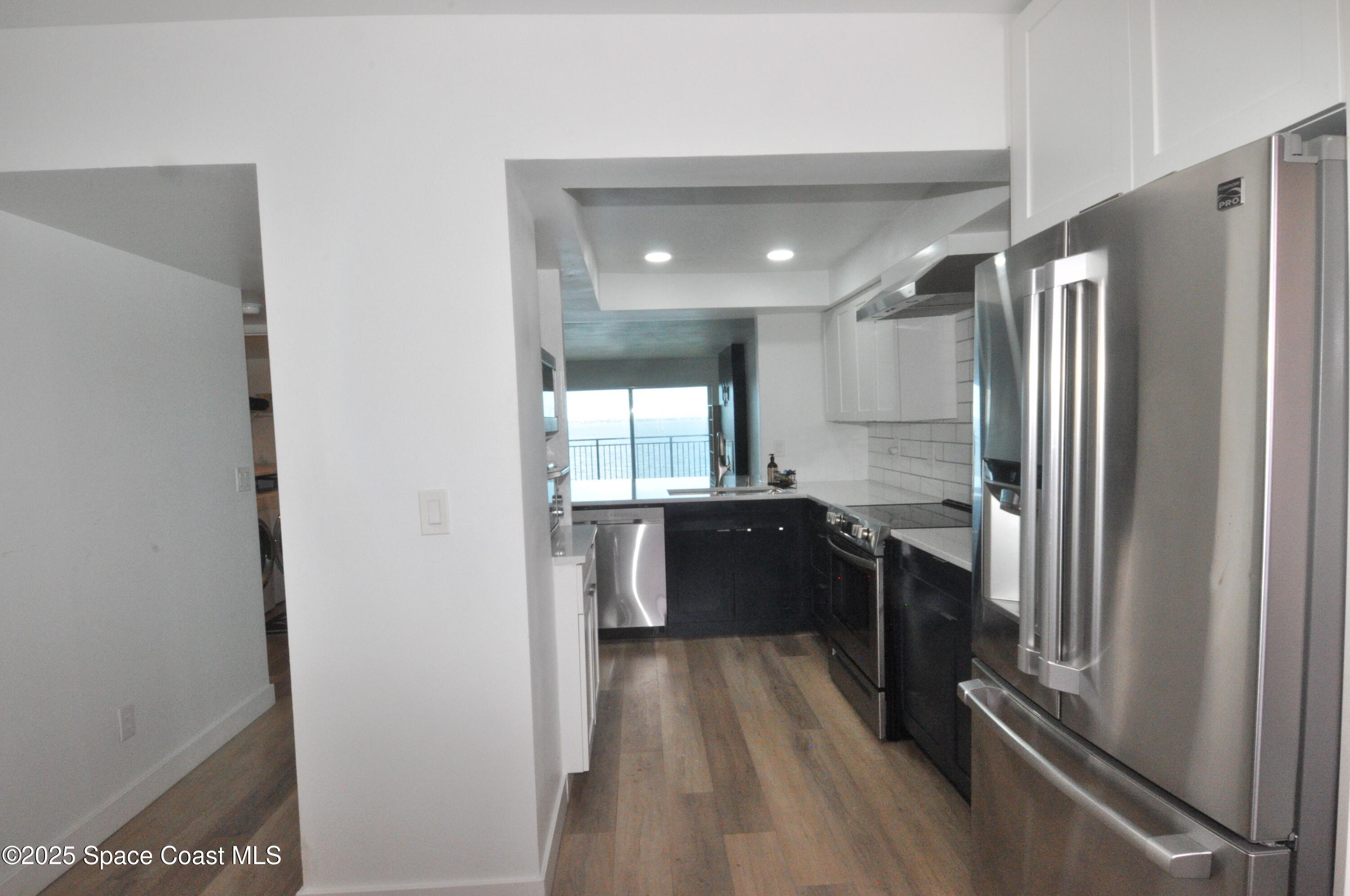 3901 Dixie Highway Northeast, Unit 402 Palm Bay, FL 32905 - Photo 17 of 33 a large bathroom with a large mirror vanity and shower