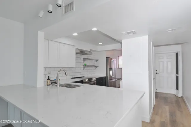 a kitchen with a sink a stove and refrigerator