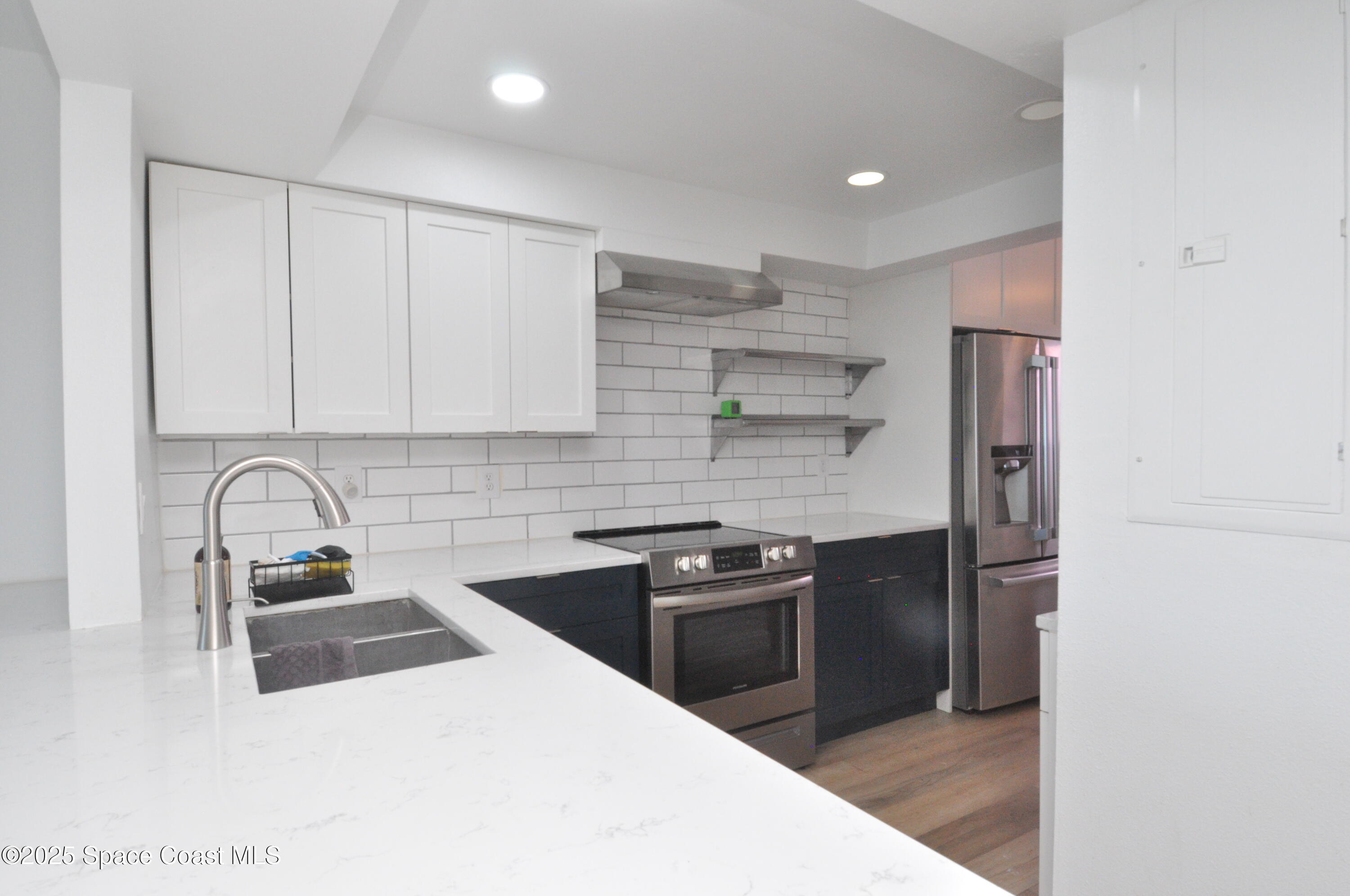 3901 Dixie Highway Northeast, Unit 402 Palm Bay, FL 32905 - Photo 20 of 33 a kitchen with a sink a stove and refrigerator