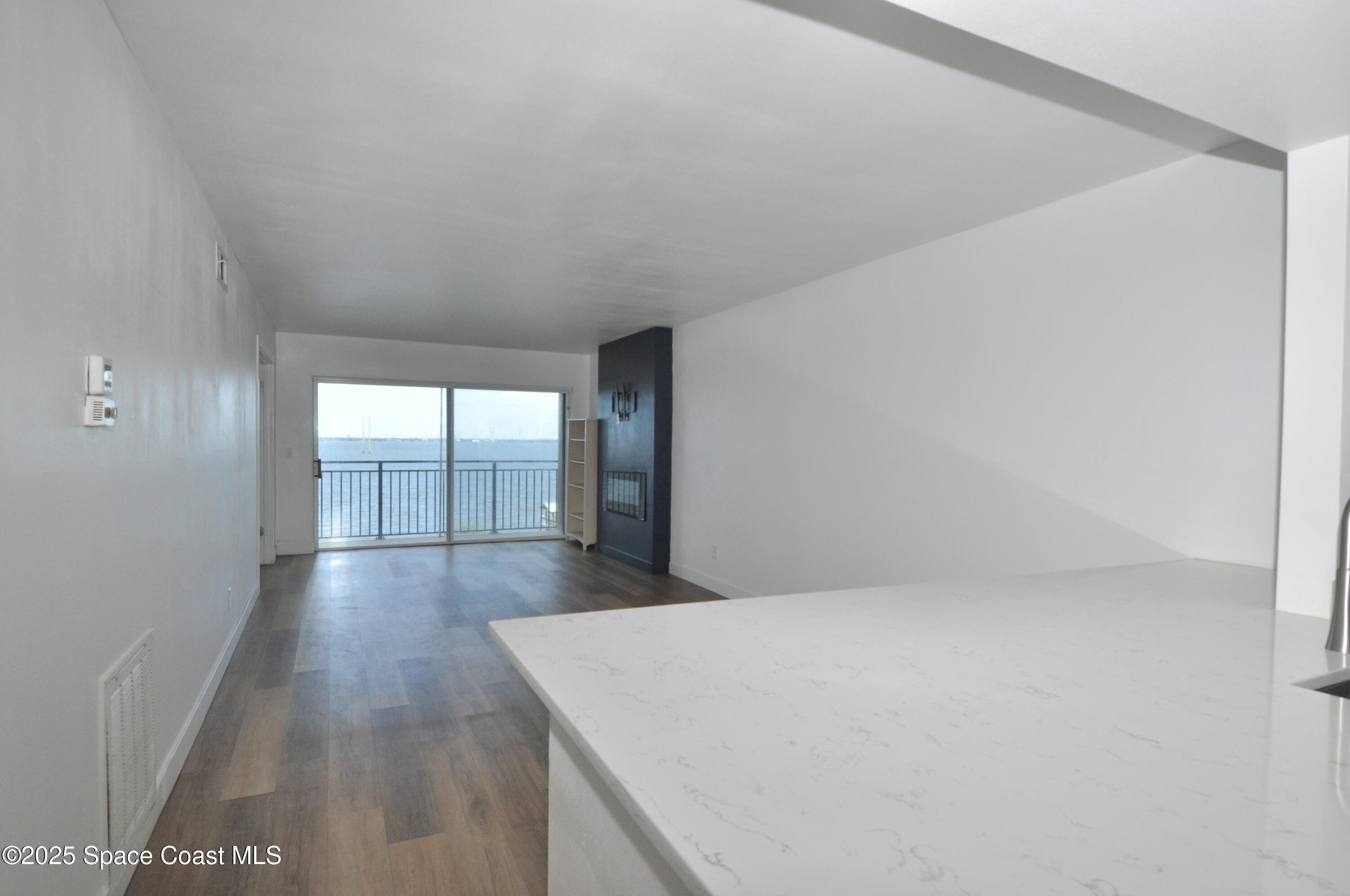 3901 Dixie Highway Northeast, Unit 402 Palm Bay, FL 32905 - Photo 22 of 33 a view of empty room with wooden floor and fan