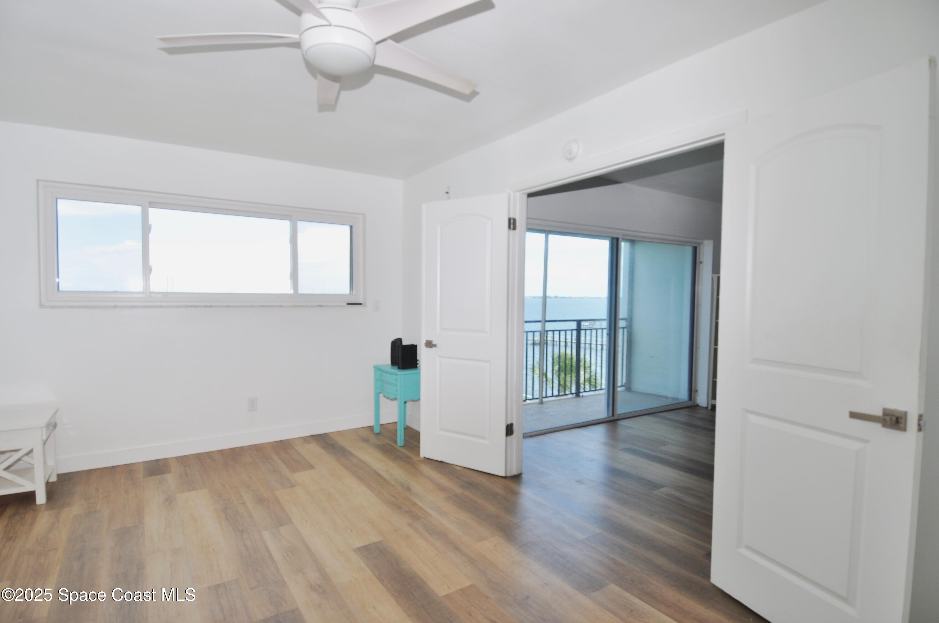 3901 Dixie Highway Northeast, Unit 402 Palm Bay, FL 32905 - Photo 26 of 33 an empty room with wooden floor and windows