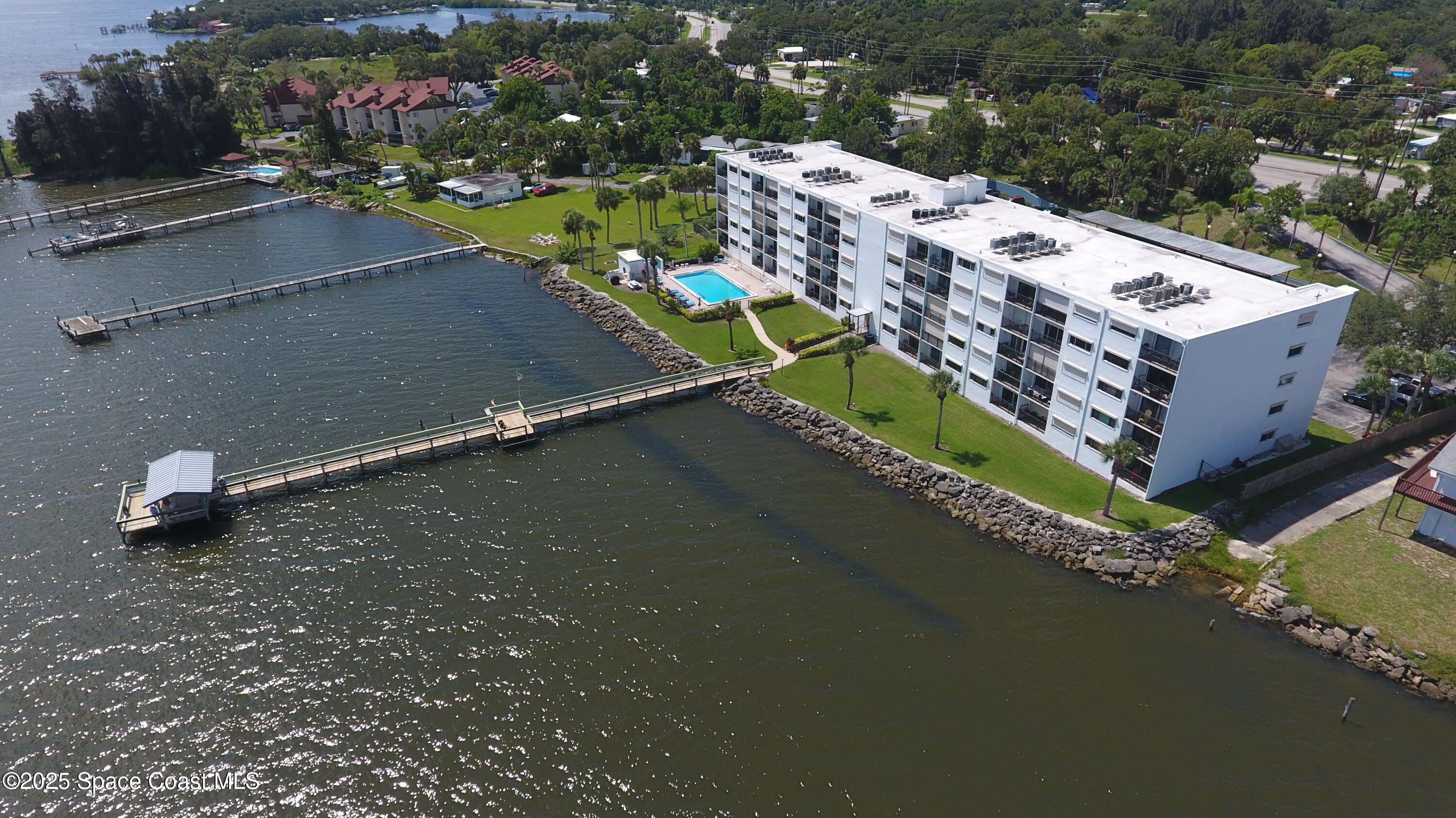 3901 Dixie Highway Northeast, Unit 402 Palm Bay, FL 32905 - Photo 3 of 33 an aerial view of a house with a garden and lake view