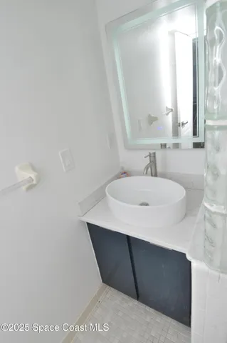 a bathroom with a glass shower door