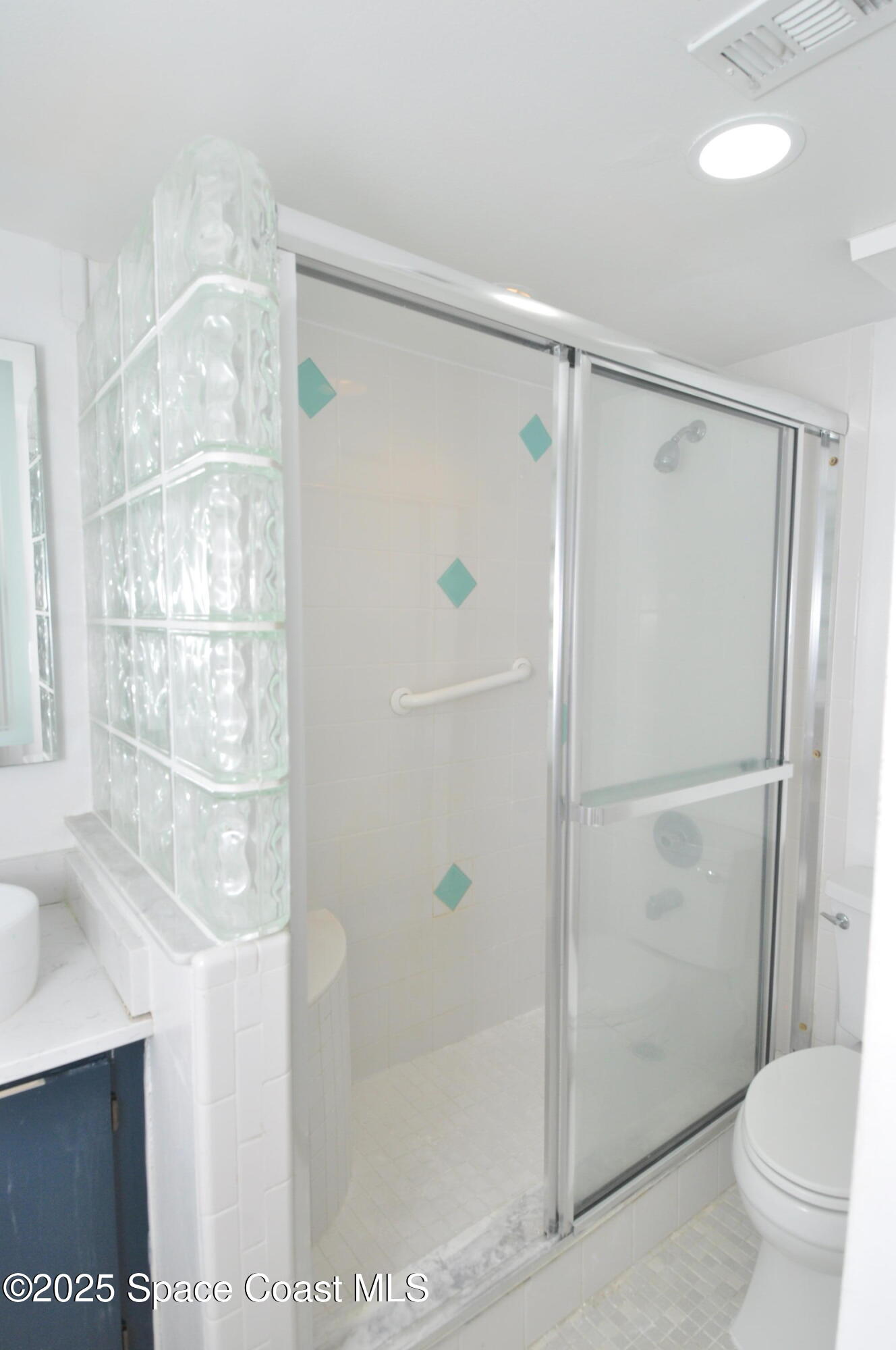 3901 Dixie Highway Northeast, Unit 402 Palm Bay, FL 32905 - Photo 32 of 33 a bathroom with a glass shower door