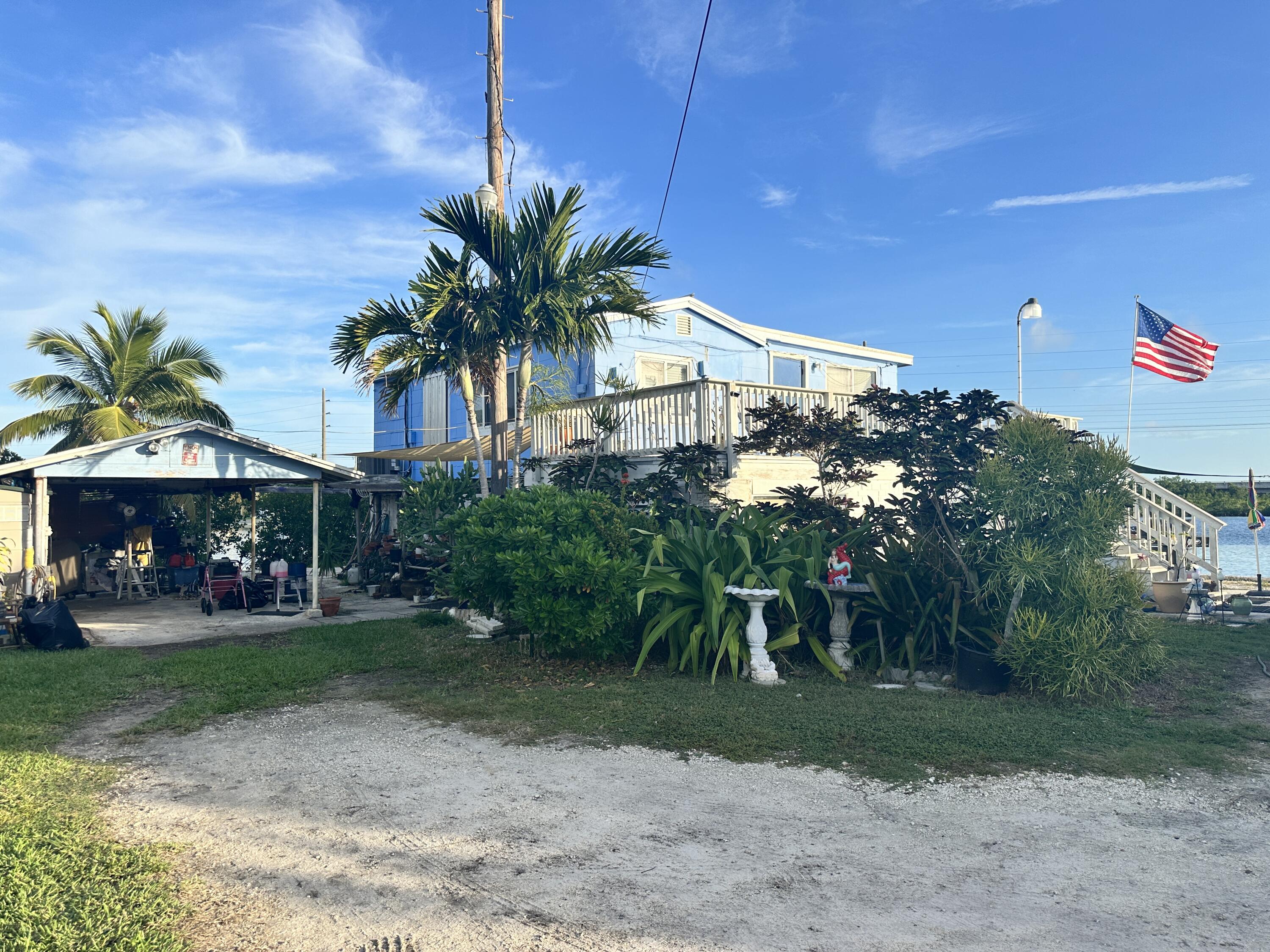 a view of a house with a yard and tree s