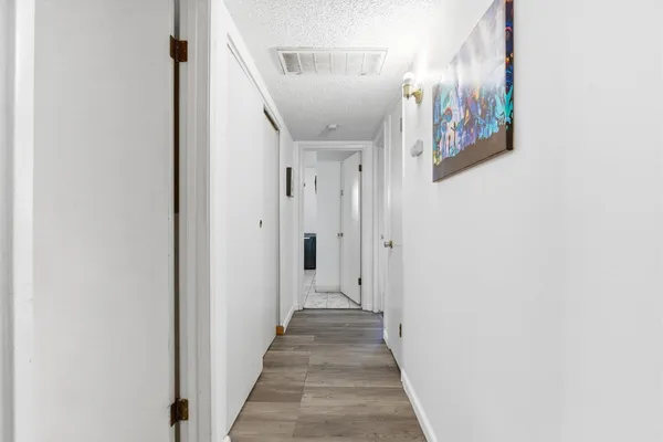 a view of a hallway with paintings on the wall