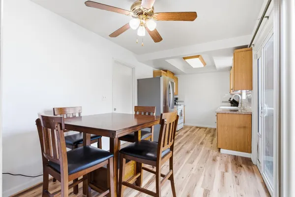 a view of a dining room with furniture and wooden floor