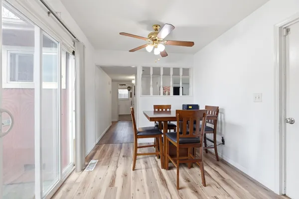 a view of a dining room with furniture and a chandelier