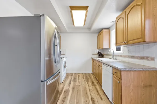 a view of a kitchen with a sink and a window