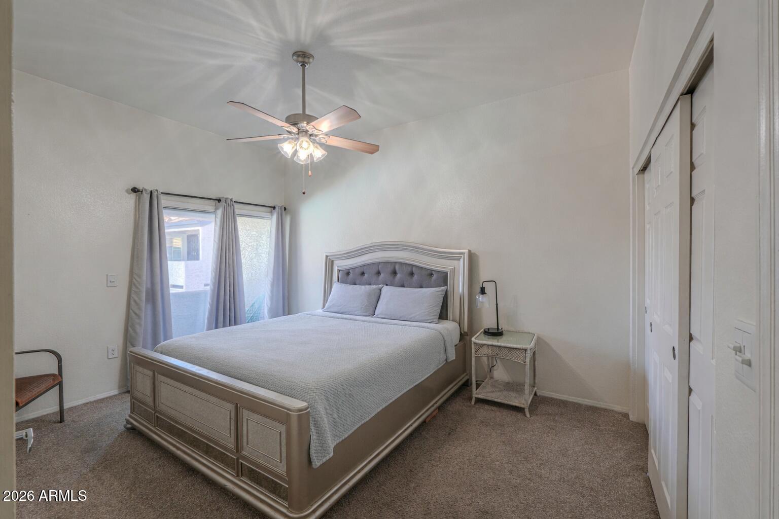 1331 West Baseline Road, Unit 225 Mesa, AZ 85202 - Photo 21 of 47 a bedroom with a bed and a chandelier