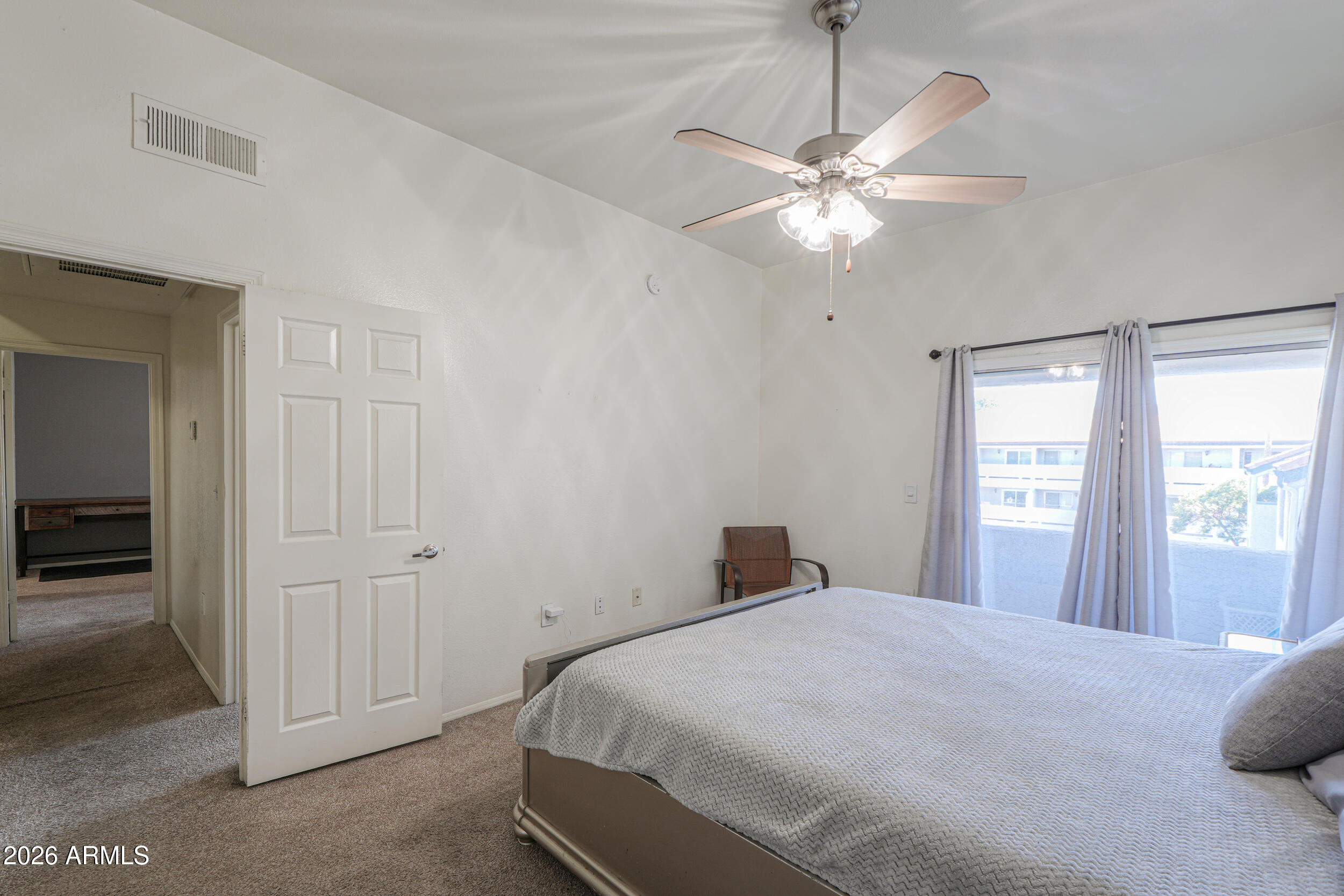 1331 West Baseline Road, Unit 225 Mesa, AZ 85202 - Photo 22 of 47 a bedroom with a large bed and a chandelier