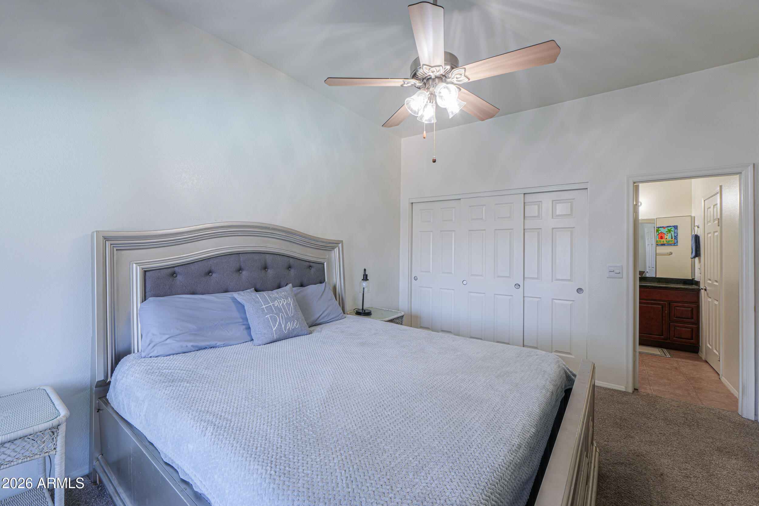 1331 West Baseline Road, Unit 225 Mesa, AZ 85202 - Photo 23 of 47 a bedroom with a bed and a chandelier