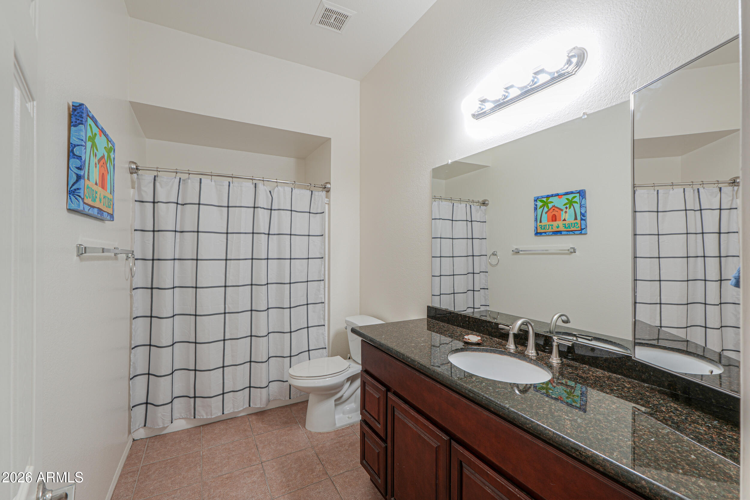 1331 West Baseline Road, Unit 225 Mesa, AZ 85202 - Photo 25 of 47 a bathroom with a granite countertop sink a toilet and a shower curtain